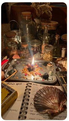 A Pinterest screenshot featuring a large number of aesthetic jars, a spellbook with a big scallop shell on it, a tarot deck, and a candle burning into a tray of herbs.